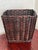 Square woven rattan wicker waste basket with gently tapered sides. It has a rich dark ebony stain. Vertical stakes carry...