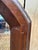 Large octagonal wall mirror with a solid, dark mahogany-stained wood frame and a beveled glass. The frame's corners are...