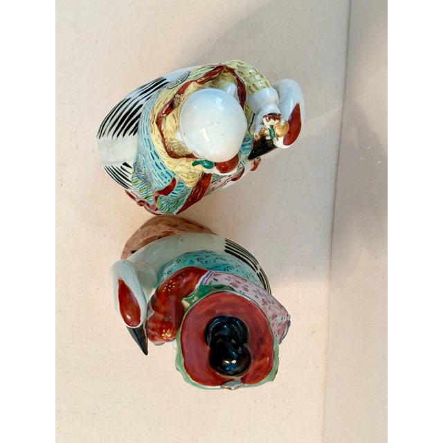 Featured in this listing is a pair of antique Famille Rose immortal statues from the Qing Dynasty in China. The statues...