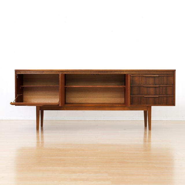 This vintage credenza was made in Glasgow, Scotland during the 1950s and designed by Neil Morris for Morris of Glasgow....