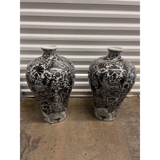 A pair of gorgeous dramatic vases in black and white with a dragon pattern . these vases would add instant drama and pop...