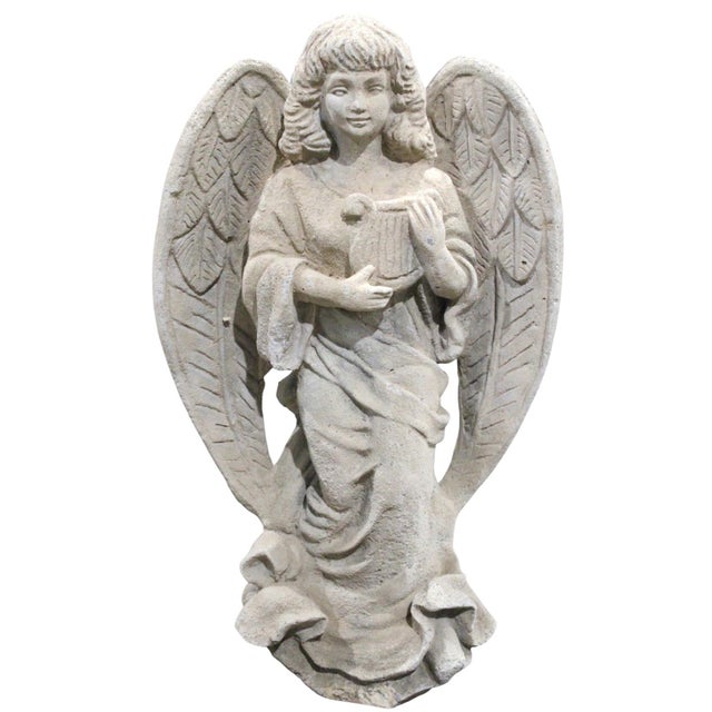A beautifully aged vintage cast stone angel sculpture with exceptional sculptural detail and an elegant, timeworn patina...