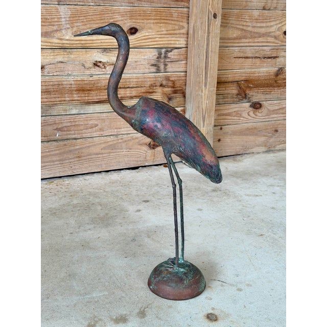 A charming vintage handcrafted heron sculpture featuring an elongated neck, slender legs, and beautifully sculpted form....