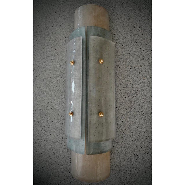 This Murano glass wall sconce features a stunning frame. A unique and rare glass, with a white "scavo" and aquamarine...