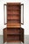 This subtle antique English bookcase/display cabinet from the 19th century, complete with a working key. This antique...