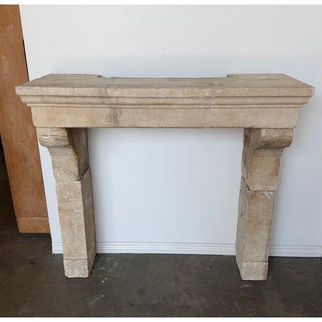 This petite French limestone mantel embodies the quiet refinement of 18th-century provincial architecture, scaled...