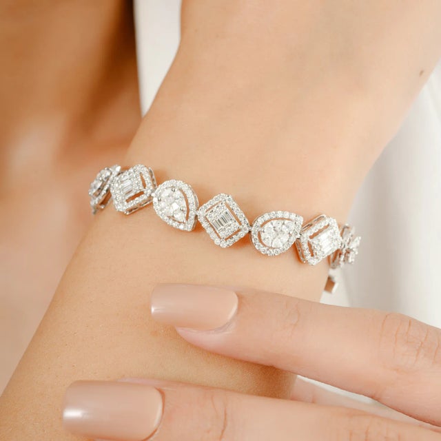 This 6.31 CTW Fine Diamond Cluster Tennis Bracelet for Engagement in 18K gold showcases sparkling natural diamonds,...