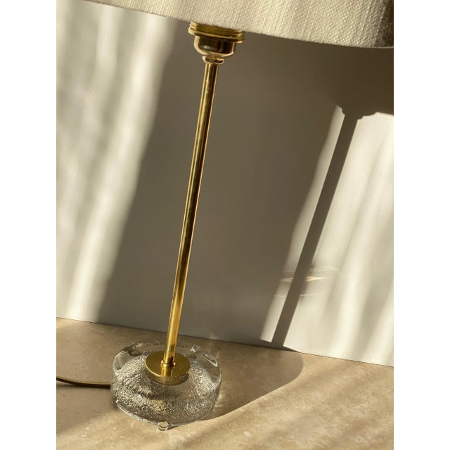 Scandinavian Modern, Clean and Minimalistic Table Lamp in Brass and Glass. Model 6275 has a stable base of pressed glass...