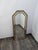 Mirror in a gilded, aged wood frame. The frame has a geometric shape with decorative mirror inserts that emphasize the...