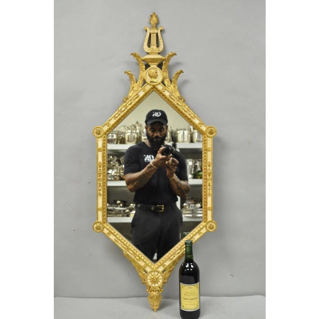 Vintage Italian Neoclassical Style Cream & Gold Gilt Carved Wood Wall Mirror with Lyre and Portrait Bust Carved Pediment....
