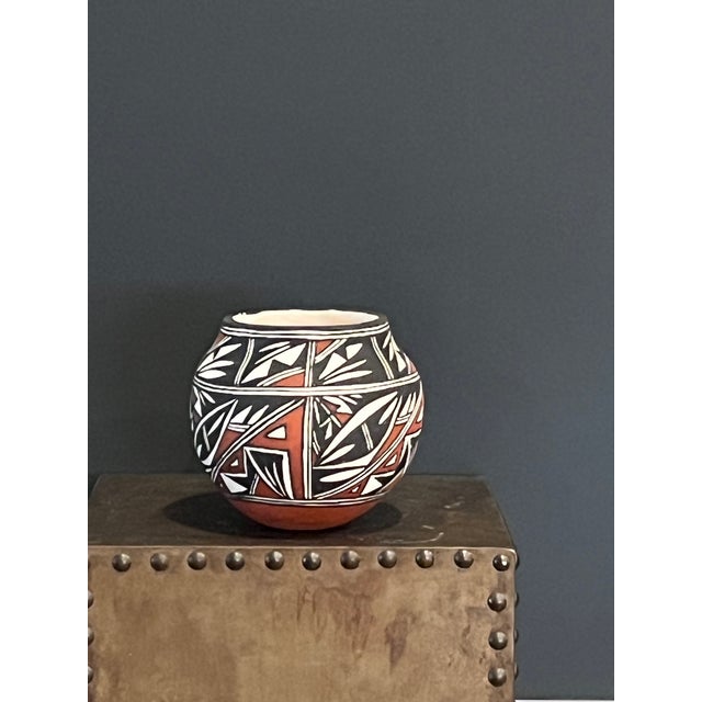 This striking hand-coiled seed jar is a premier example of contemporary Acoma Pueblo pottery from New Mexico. Standing...
