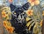 A black panther portrait sits centered in a dense tropical field of monstera leaves and orange hibiscus flowers. The...