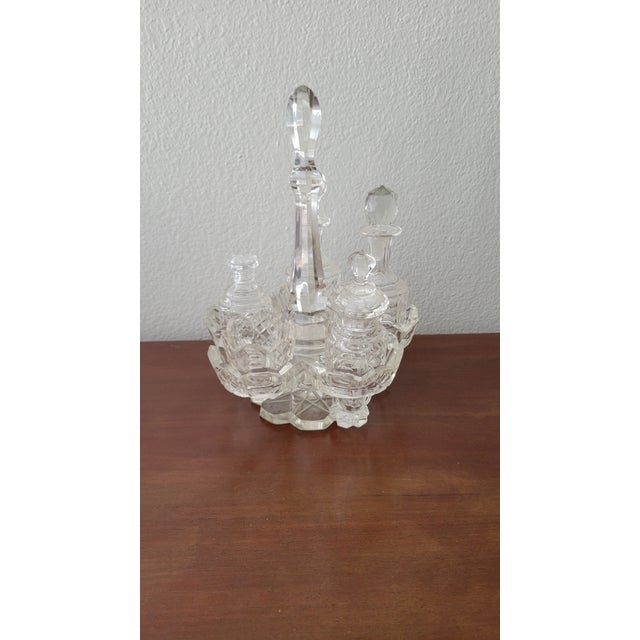 Beautiful vintage cruet set. The set consists of four bottles with stoppers one peper dip, and the holder. The holder...