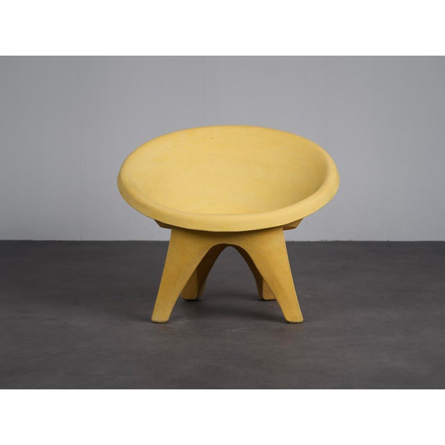 A striking pair of sculptural lounge chairs from italy, dating to the 1960s. Cast in concrete, the design is defined by...