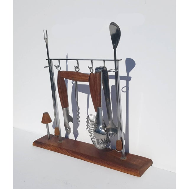 Walnut and chrome utensil set with three decorative corks.