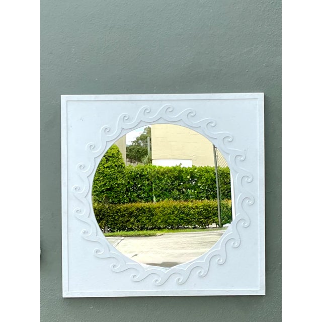 Exuding refined coastal elegance and organic mid-century design, this vintage aluminum wall mirror makes a striking...