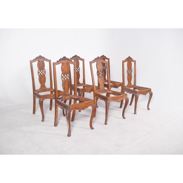 Set of six dining chairs. with cut-out and hollowed-out backrests, it features a double medallion joined by geometric...