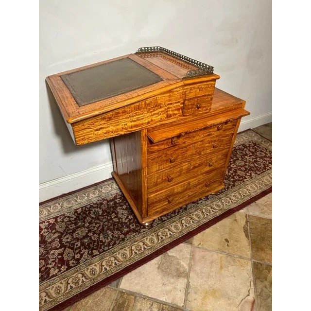 Immerse yourself in the elegance of the past with this exquisite Antique William IV Satinwood Davenport Desk. Crafted with...