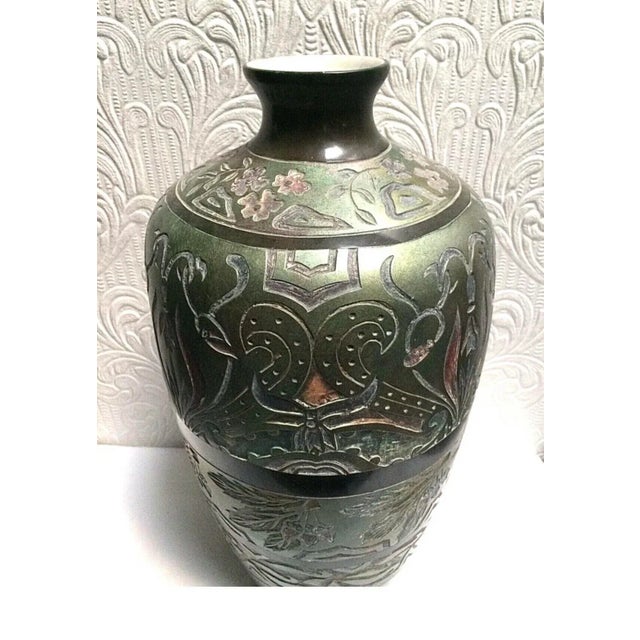 Beautiful, rare, carved antique hand made art pottery 19" tall vase in irresdescent colors. It is not signed so I don't...
