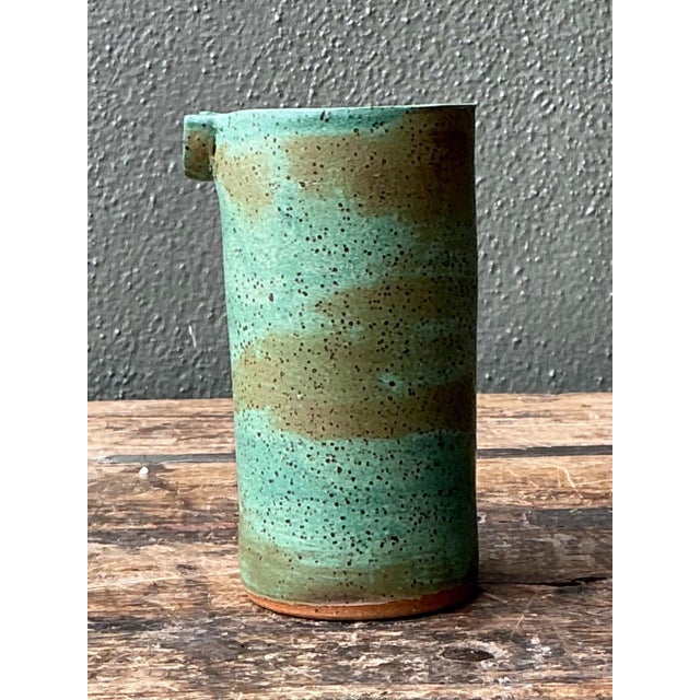 This vintage studio pottery stoneware vase is a refined expression of mid-century ceramic design, distinguished by its...