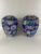 A pair of round famille rose style porcelain vases or ginger jars with polychrome floral decoration on a cobalt blue...