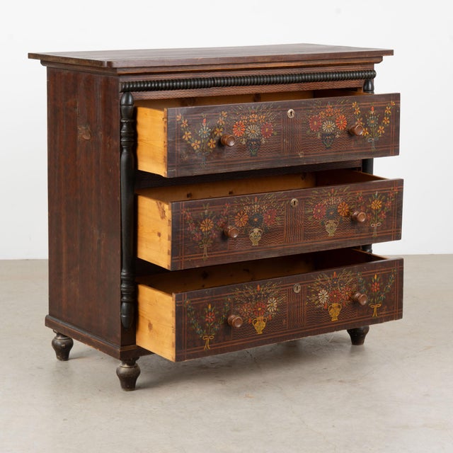 19th century tall Hungarian chest of three drawers, crafted in pine with its original hand-painted folk art finish. A...