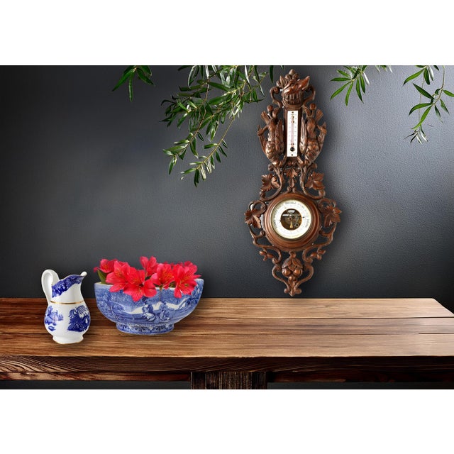 This large antique Black Forest barometer features masterful hand-carved details, showcasing the artistry of traditional...