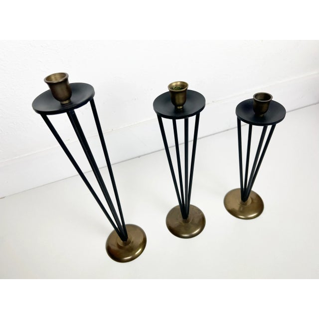 Vintage set of three black enameled metal and brass candleholders in varying size. Origin: USA Year 1950-60s Dimensions:...