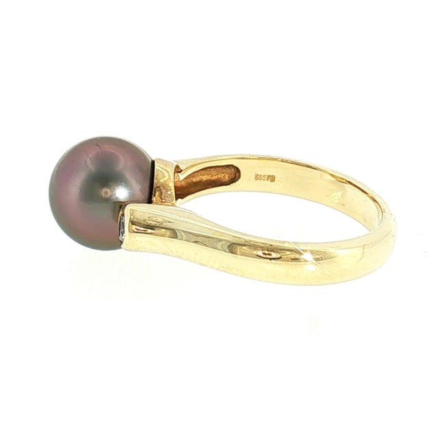 A contemporary 14k yellow gold ring featuring a peacock-colored Tahitian cultured pearl. Accented by a brilliant-cut white...