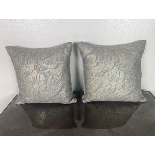 An elegant pair of custom pillows crafted from iconic Fortuny textile, featuring a luminous metallic brocade pattern set...