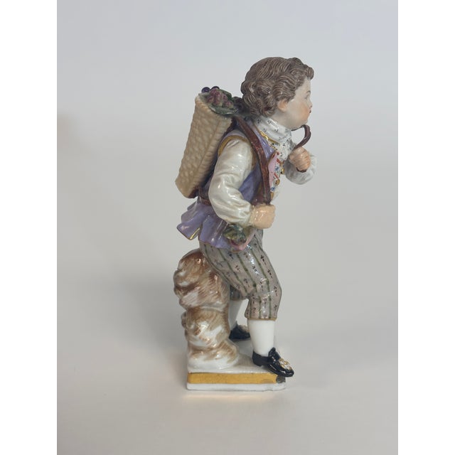 From the "Gartnerkinder" Series designed by Michael Acier in the 1770's this is a 19th Century figure of a young grape...
