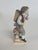 From the "Gartnerkinder" Series designed by Michael Acier in the 1770's this is a 19th Century figure of a young grape...
