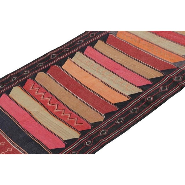 This vintage 5x13 Persian Kilim is handwoven in wool, and originates circa 1950-1960. Connoisseurs may also note that Rug...