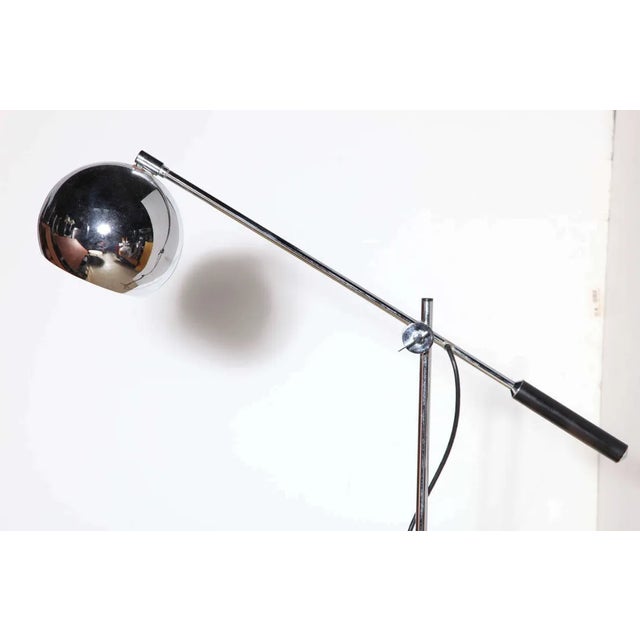 Articulating Arteluce style chrome, black enamel and leather handle tripod reading floor lamp, 1960's. In the manner of...