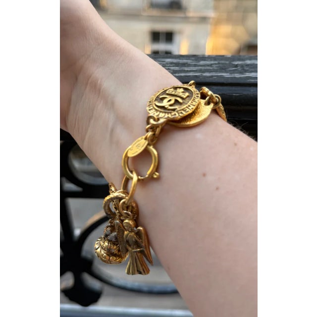 Beautiful 1990s Chanel Charm bracelet purchased in Paris, France. Rare Chanel item from the 1990s. Some patina on charms...