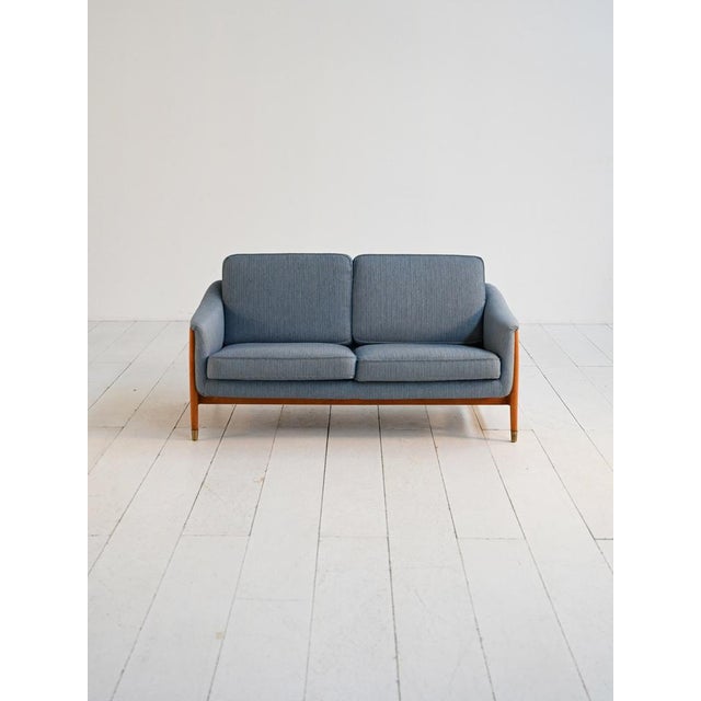 Scandinavian two-seater sofa with wooden frame, brass tips, and original upholstery. "Scania" model, designed by Folke...