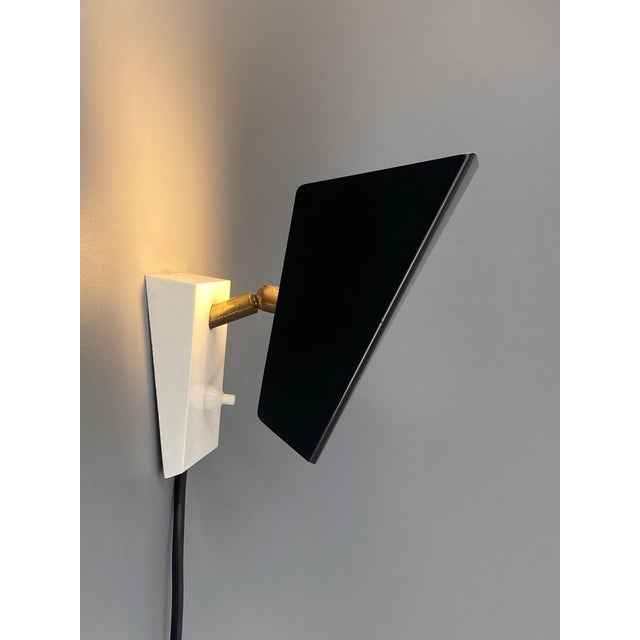 A lamp * Manufacturer: HOSO * Model: 1446 * Black sheet metal lampshade * Adjustable light angle thanks to the articulated...