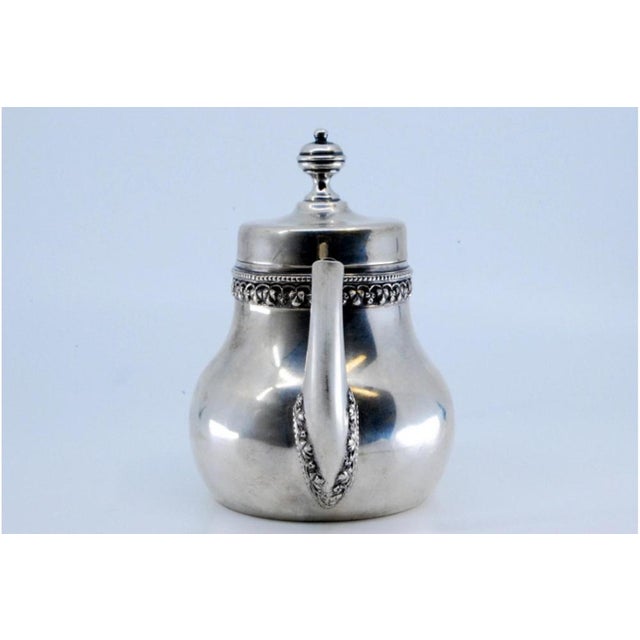 Smooth Silver Coffee Pot with Grooves on the Rim and Spout, in Very Good conditions. Designed 1890 to 1919 This piece has...