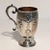 Silver embossed and chiselled glass with flower design and a wavy handle and golden interior. English manufacture town of...