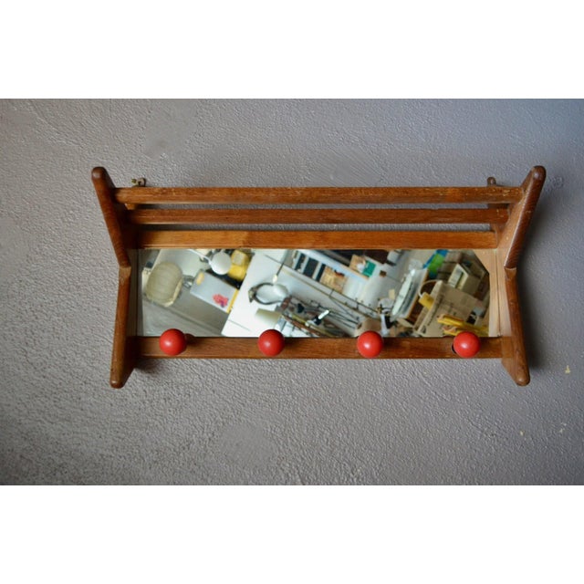 This wall-mounted coat rack, a quintessential mid-century piece, is a true vintage gem. Made of oak, its dynamic, angular...
