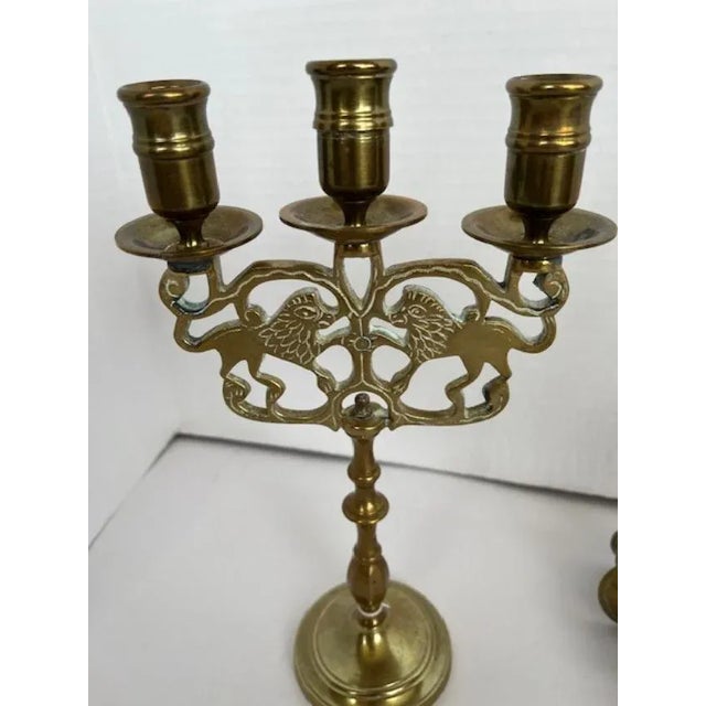 Pair of three light candle holders with lion motif. The base stem of each holder is 3.5 diameter while the actual holder...