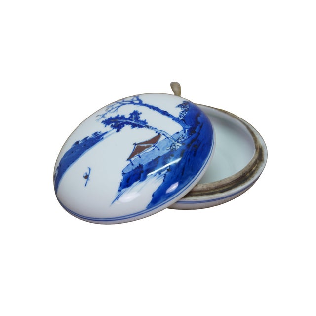 Antique Chinese Qing blue and white round paste box featuring a mountain landscape scene with pagoda and fisherman....