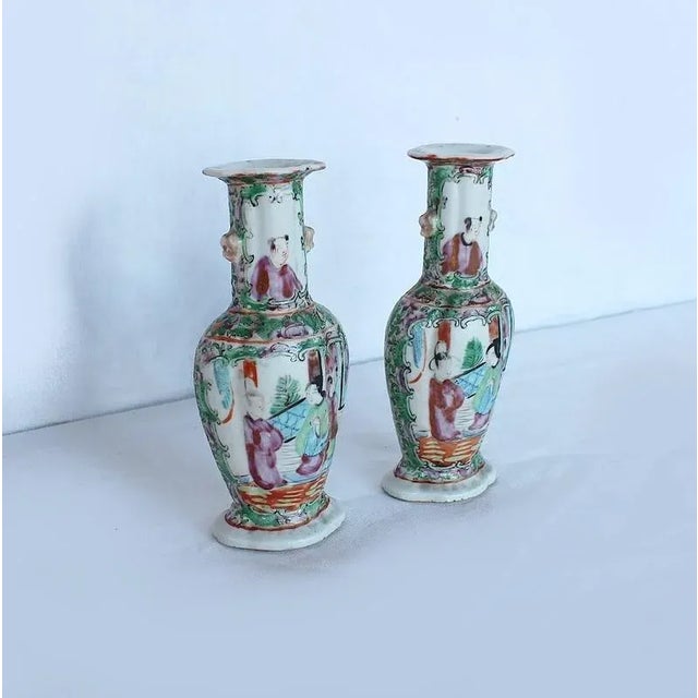 Pair of small Chinese porcelain vases, decorated with characters, birds, flowers and foliage. Each vase illustrates a...