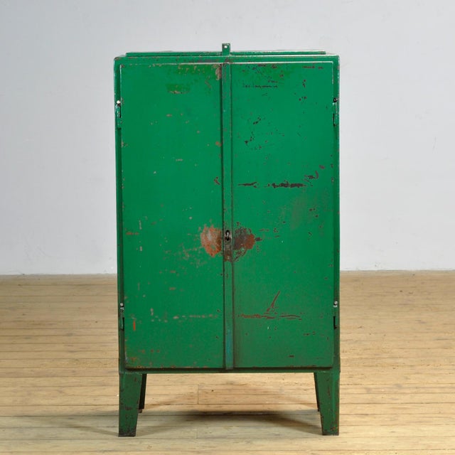 Industrial cabinet from the 1970s, made of iron. This robust eye-catcher has a practical top flap and offers a surprising...