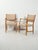 A pair of Swedish "Futura" chairs by David Rosén for Nordiska Kompaniet, featuring a slender teak frame and light-colored...