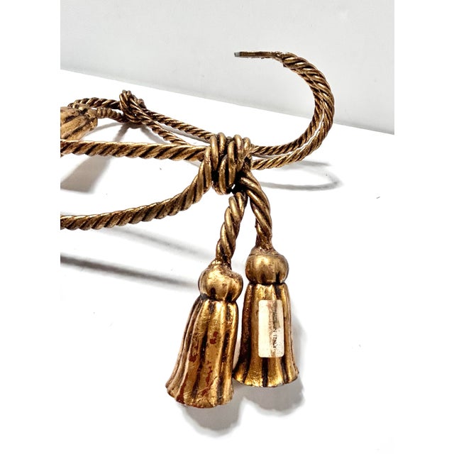 Elegant pair of vintage rope-style curtain tiebacks featuring twisted gilt cords finished with substantial decorative...