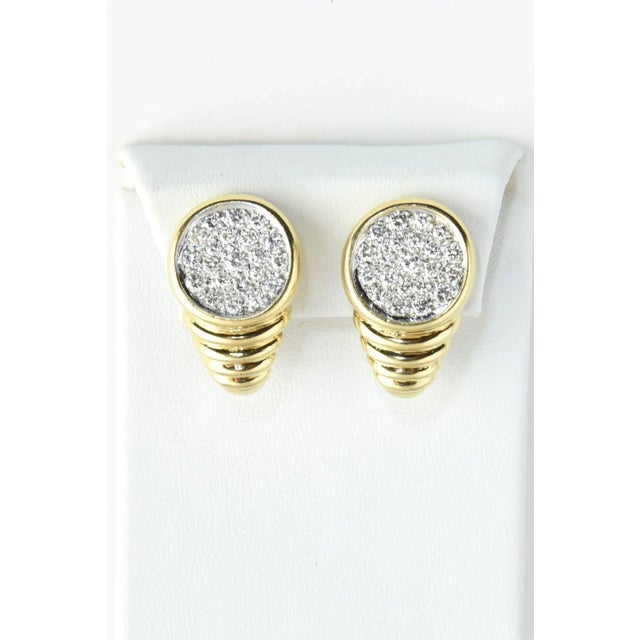 Beautifully made 1970's earrings featuring a 14k white gold circle set with approximately 2 carats of pave diamonds. The...