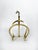 Brass magazine rack with an elegant, sculptural design typical of the 1970s. Its rounded arched structure gives it a...