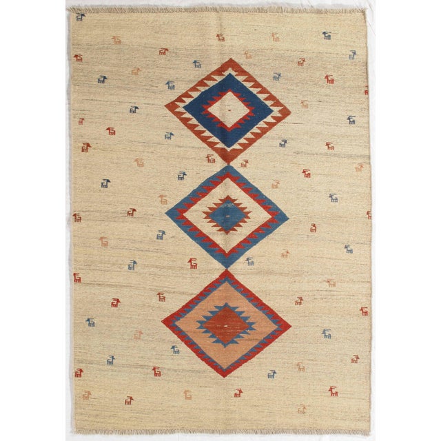 Vintage hand-knotted Sumak rug featuring a striking vertical arrangement of three geometric medallions set on an ivory...
