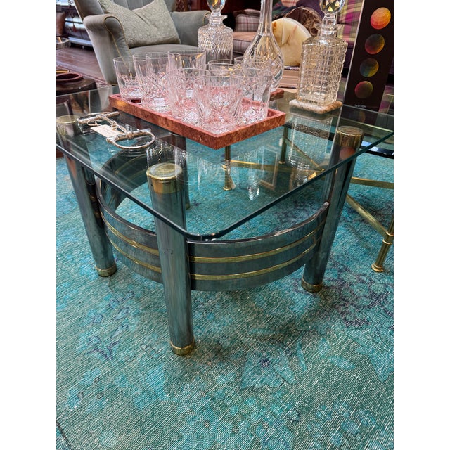 Bring vintage sophistication to your space with this Vintage Brass and Smoked Glass Side Table, likely dating to the late...